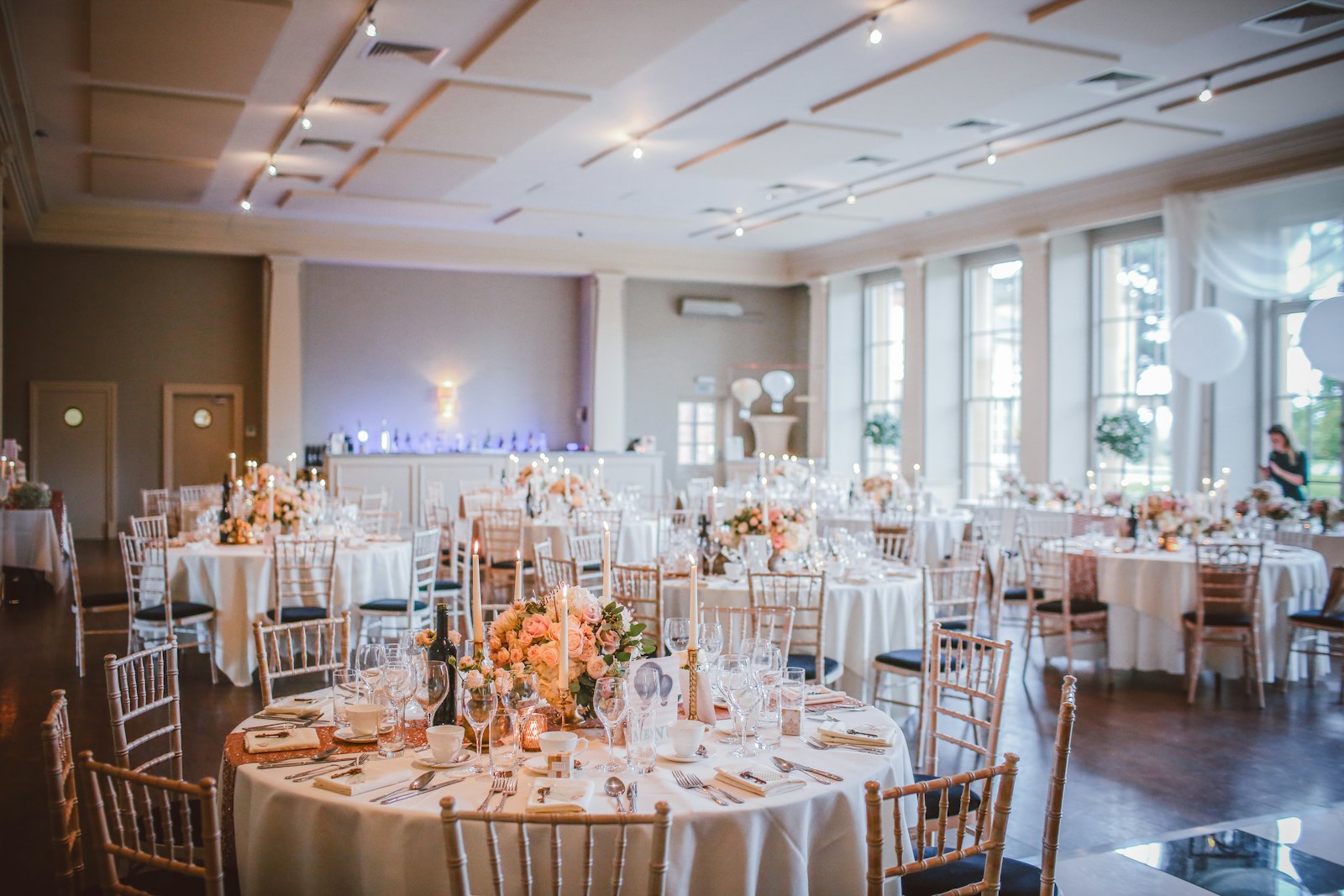 A private dining room set with long tables and candles