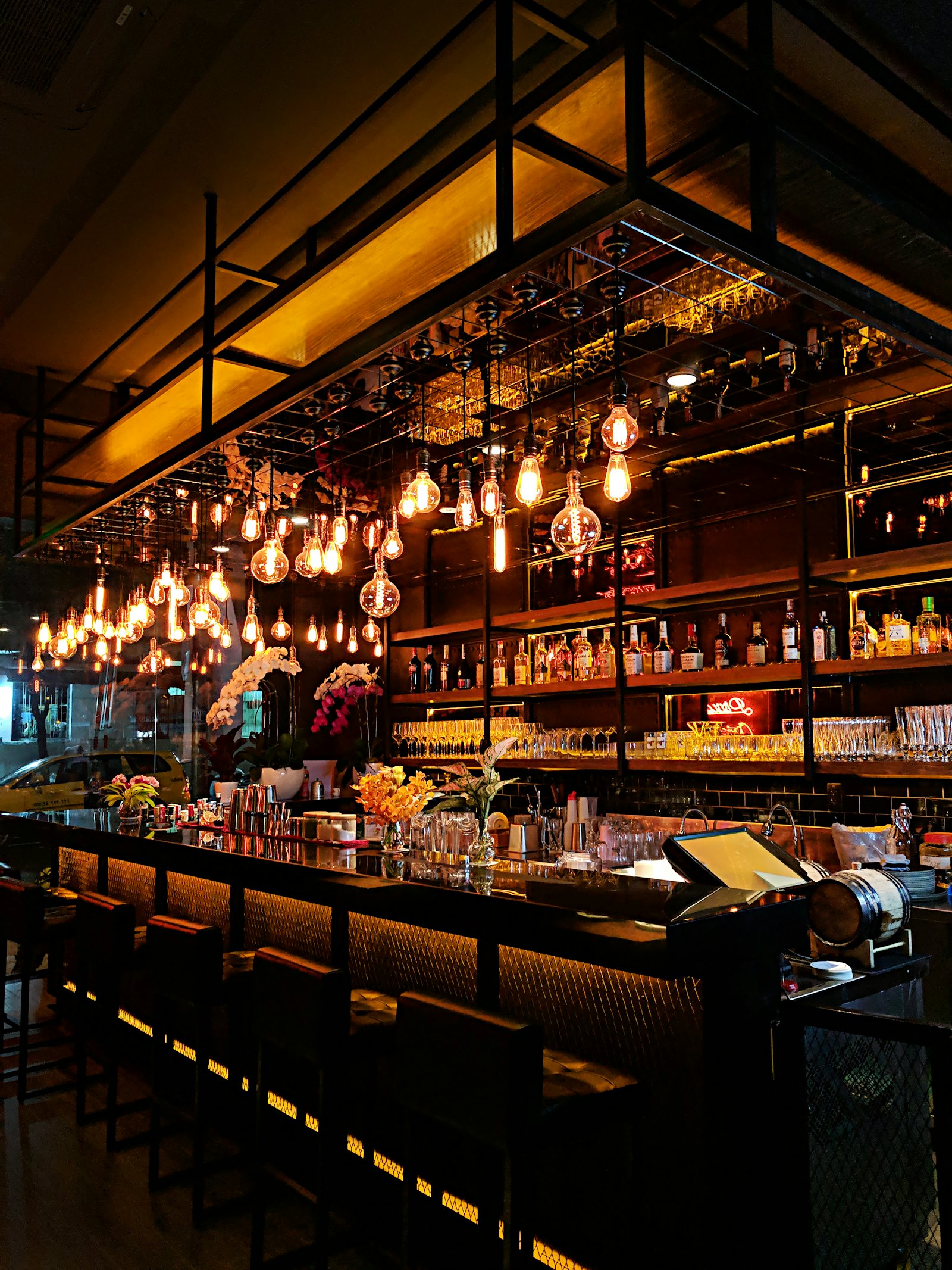 The warmly lit bar and dining room at Orlo in the evening