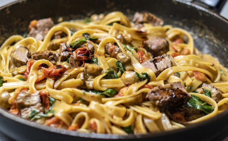 Tagliatelle tossed in a pan with slow-braised ragù